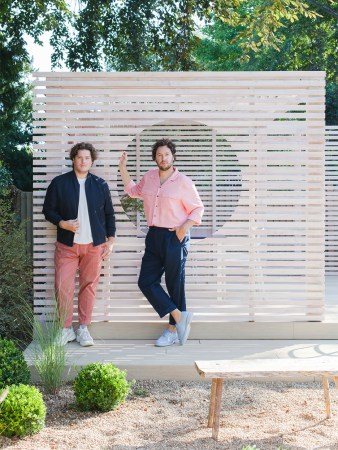 men leaning on wall