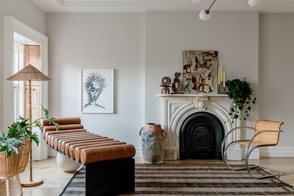 fireplace next to leather chaise