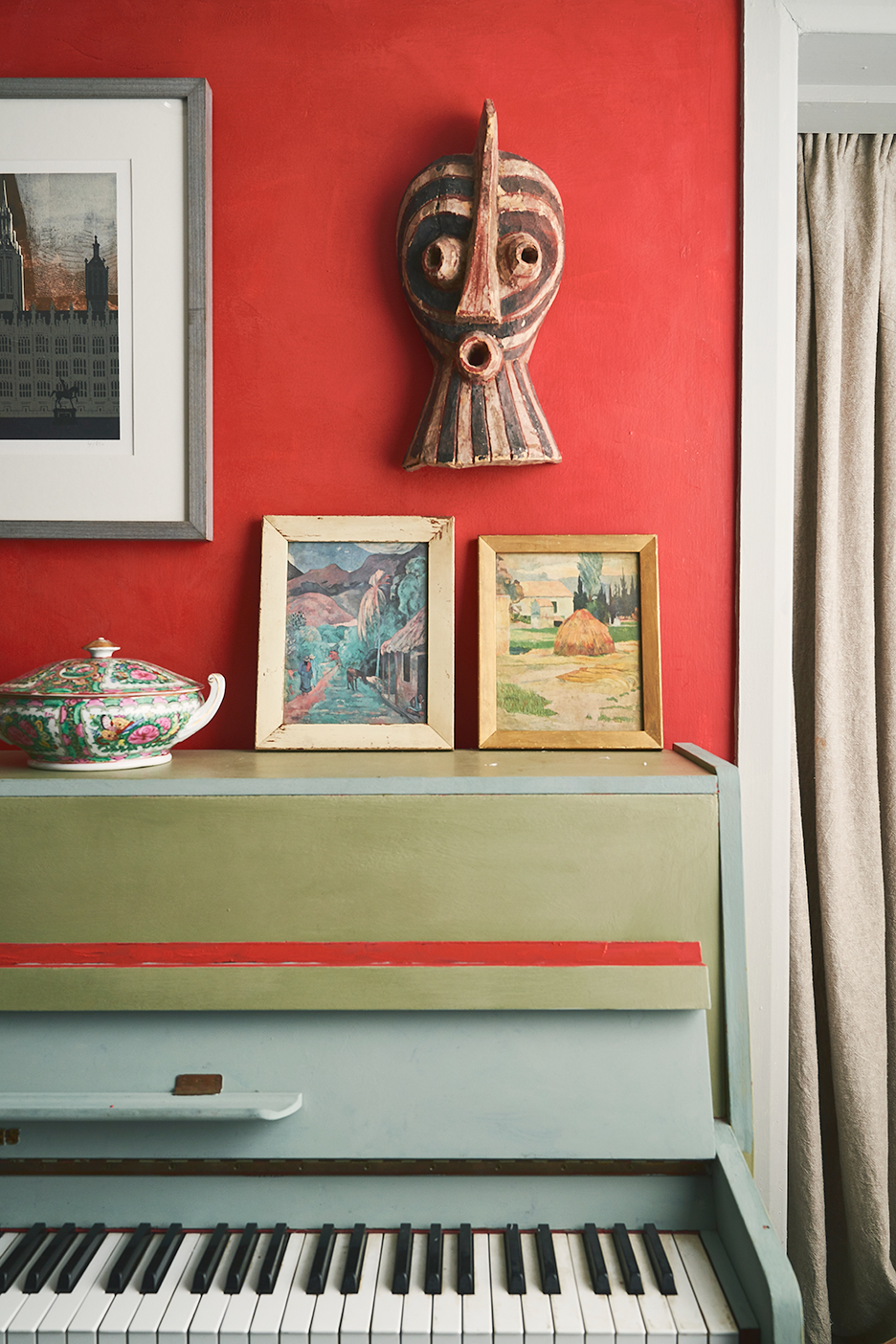 gray piano in front of red wall