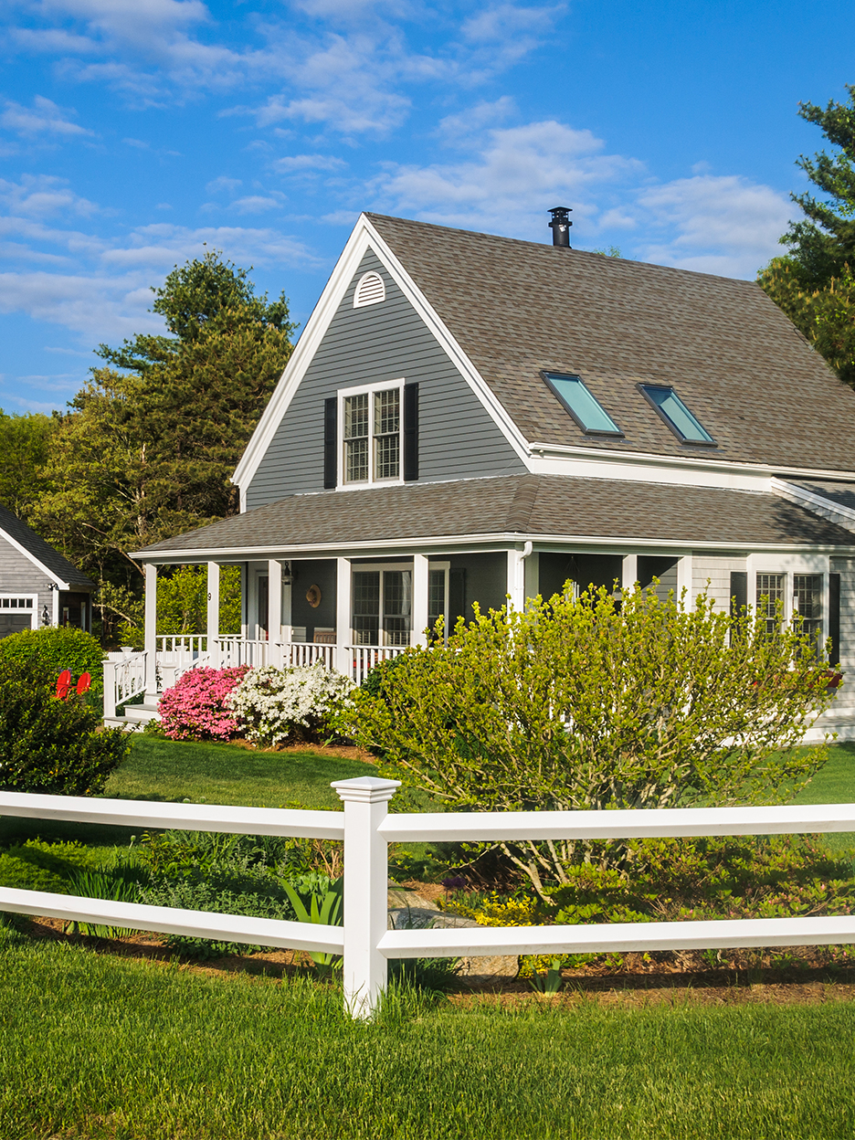 blue house in lush yard