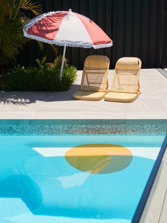 lounge chairs next to pool