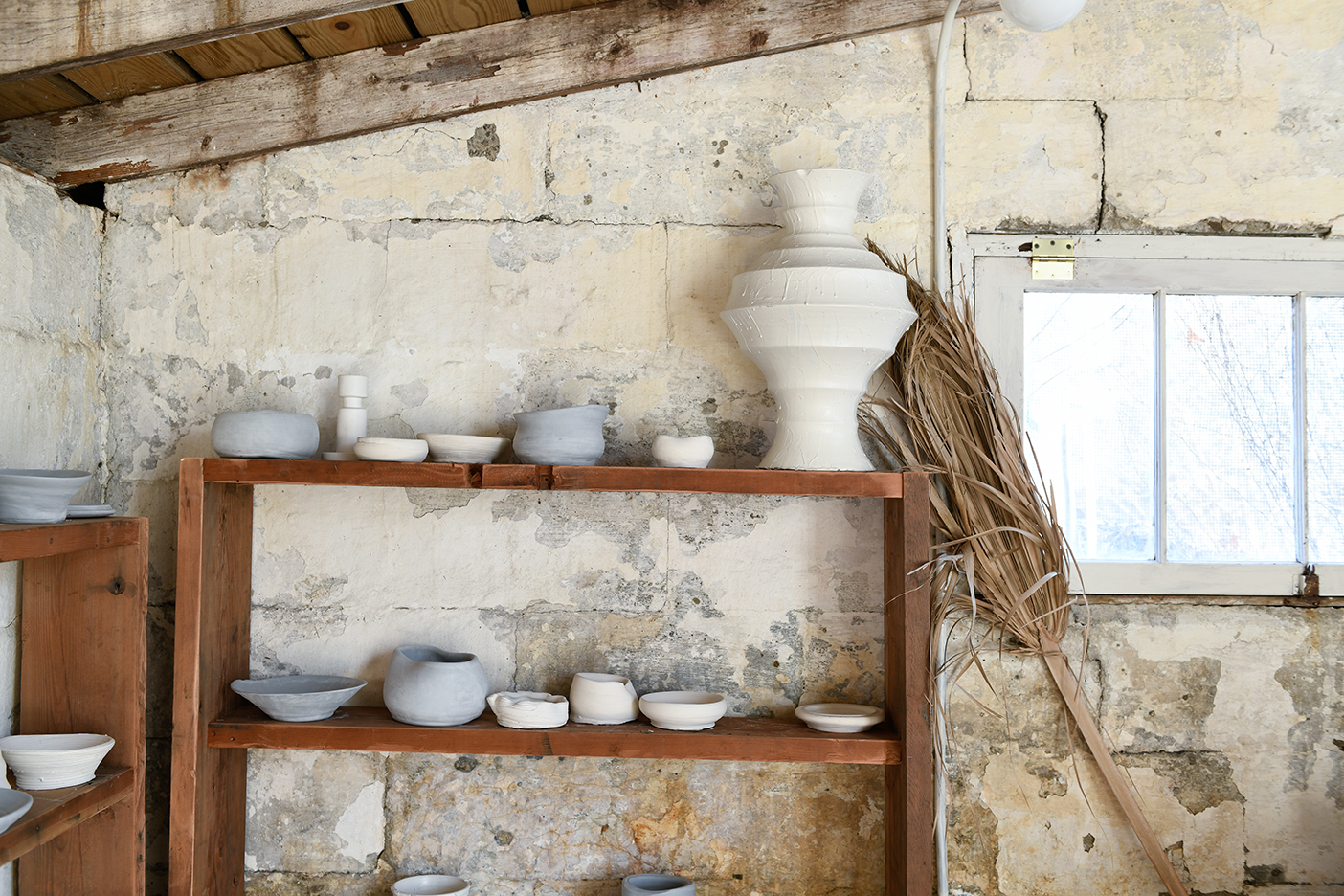 pottery drying on shelves