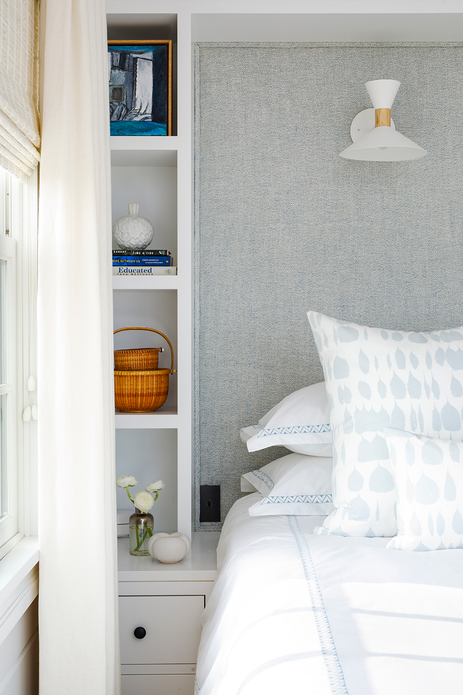 detail shot of pale blue and white bedding and bookshelf nightstand