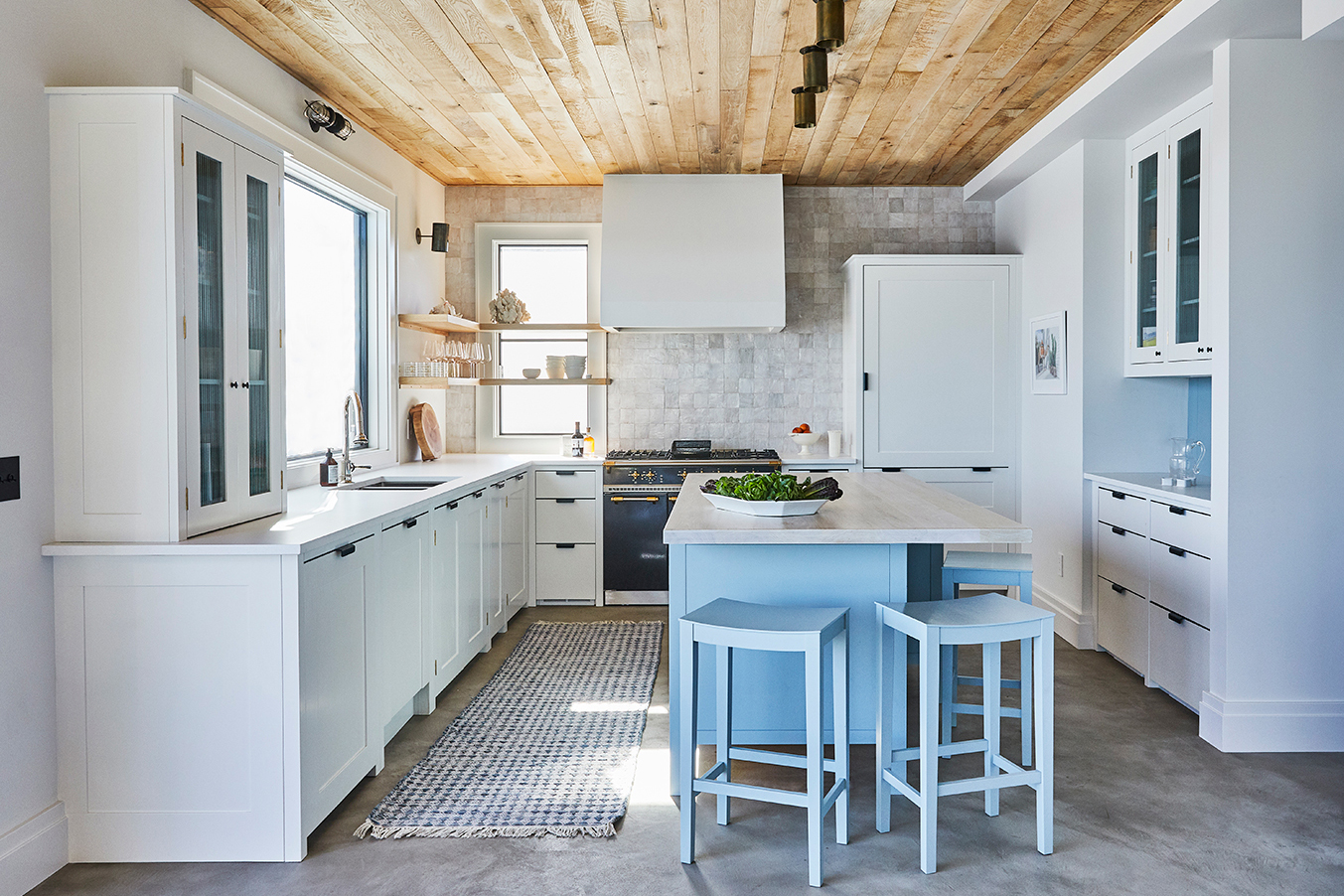 gray kitchen with baby blue island and wood ceiling