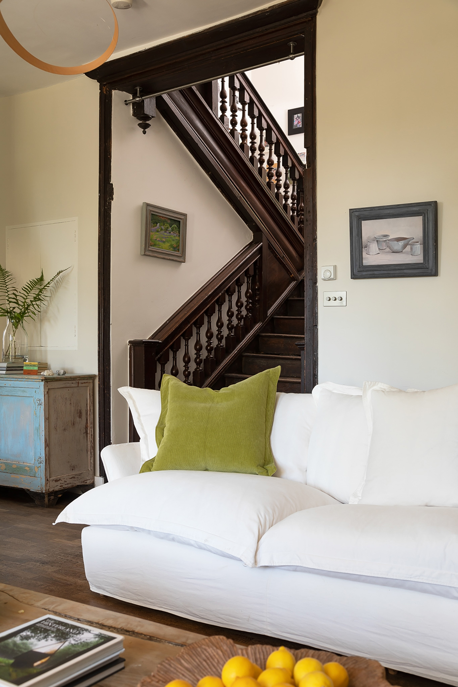 white sofa with green throw pillow