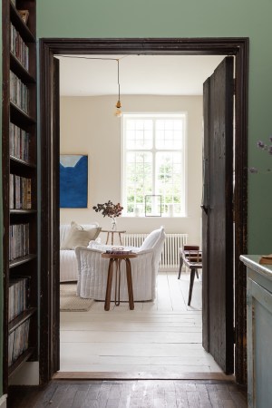 green hallway looking into living room