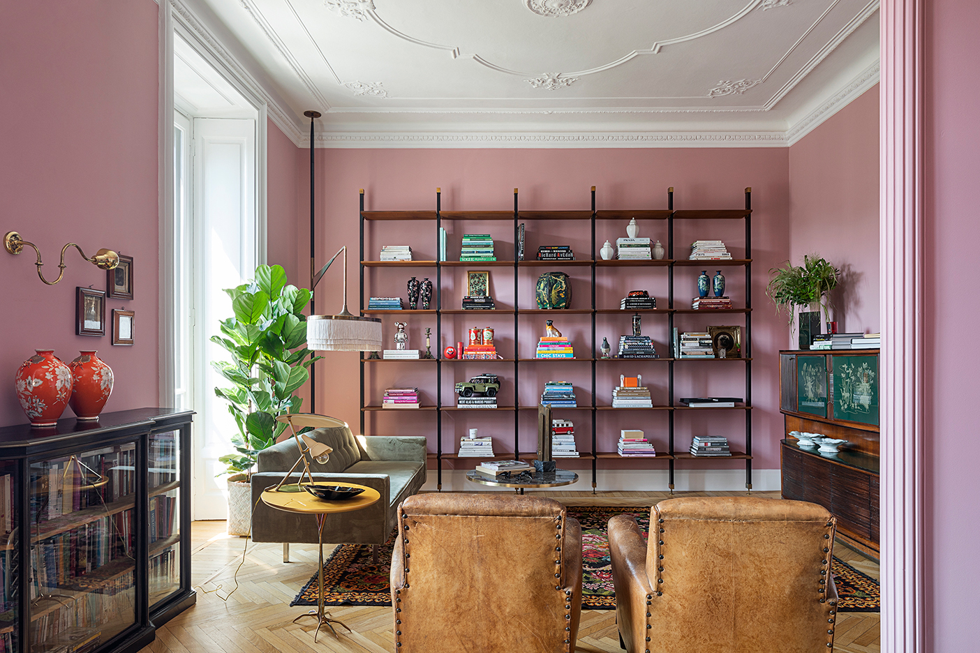 Living room bookshelves with pink walls