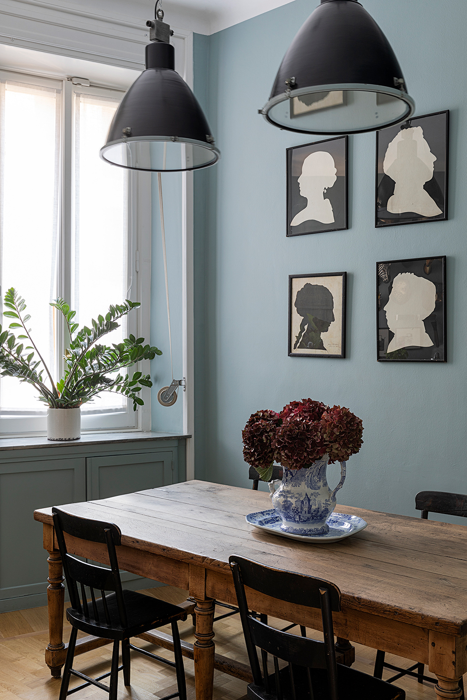 Kitchen table and silhouettes hanging on the wall