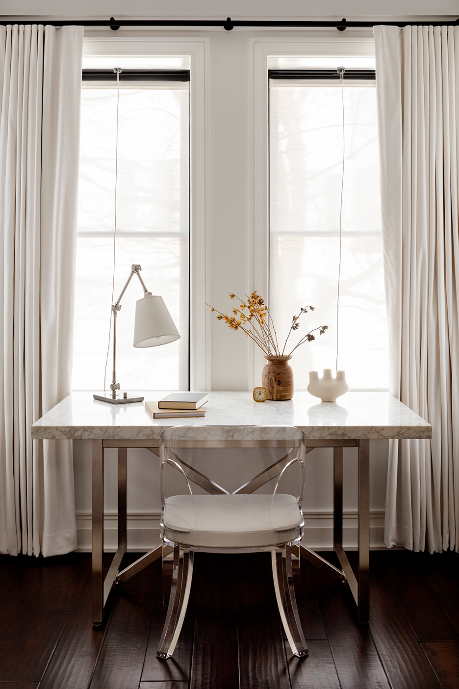 White marble desk pushed up to a window