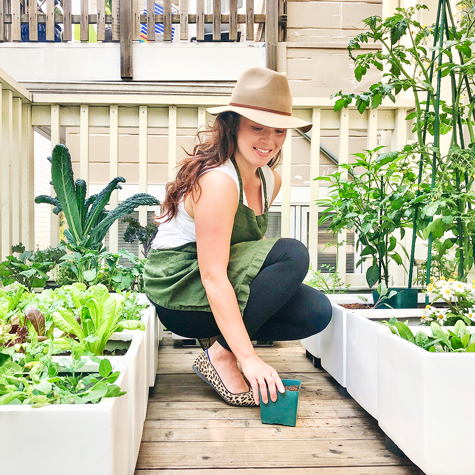 woman kneeling in balcony garden