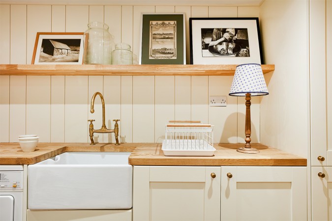 cream kitchenette with wood floating shelf