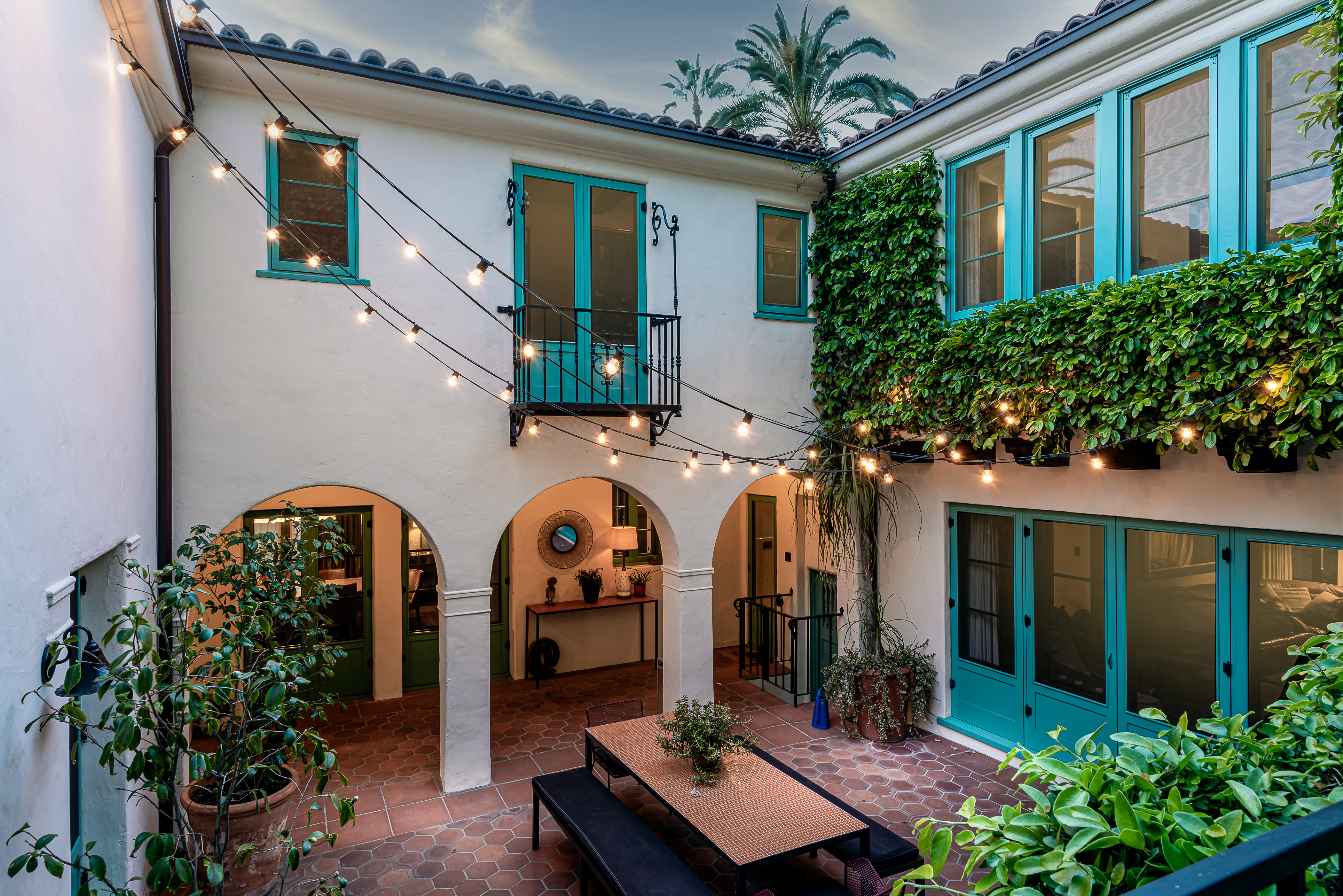 Courtyard of a Spanish Colonial-style home with aquamarine doors