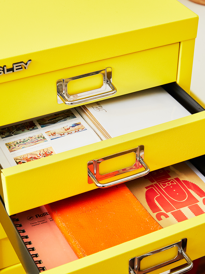 Cabinet drawers open with stationery inside