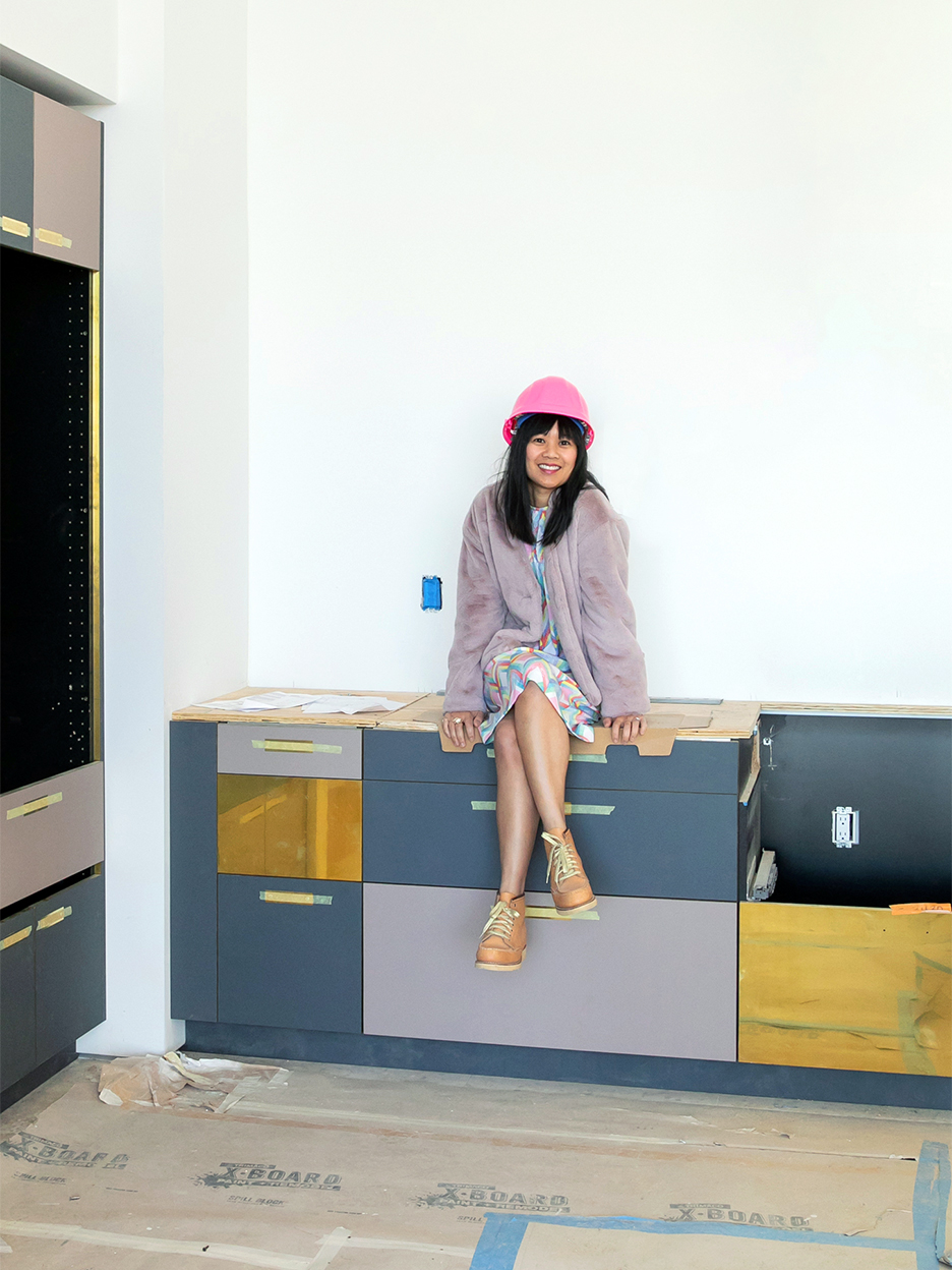 woman sitting on cabinets