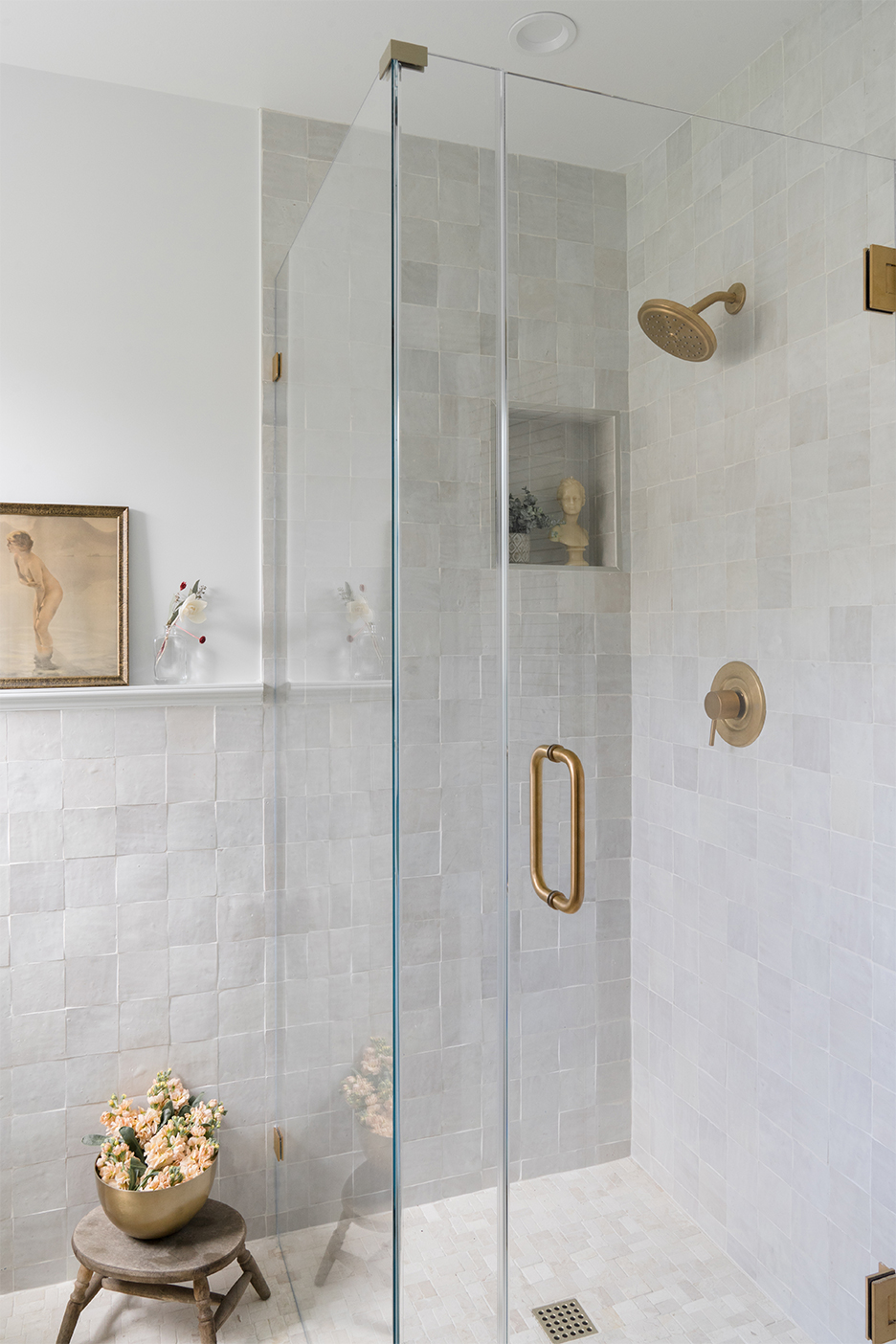 White zellige tile shower with brass hardware