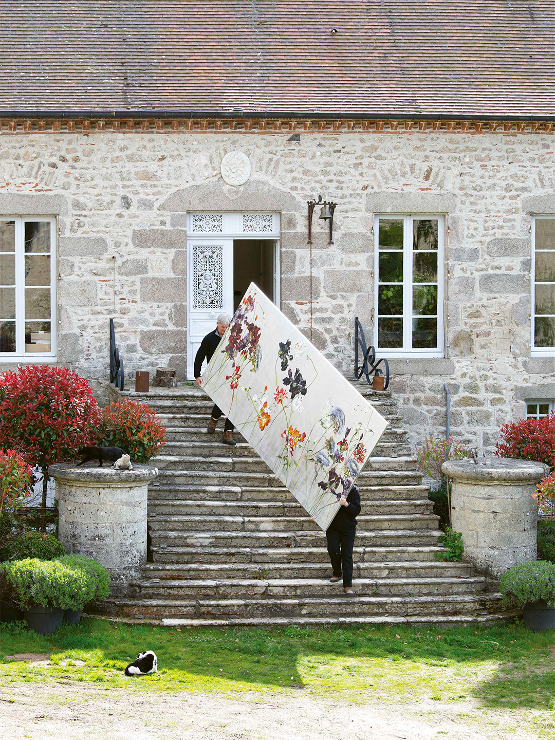 Couple carries a painting into their home