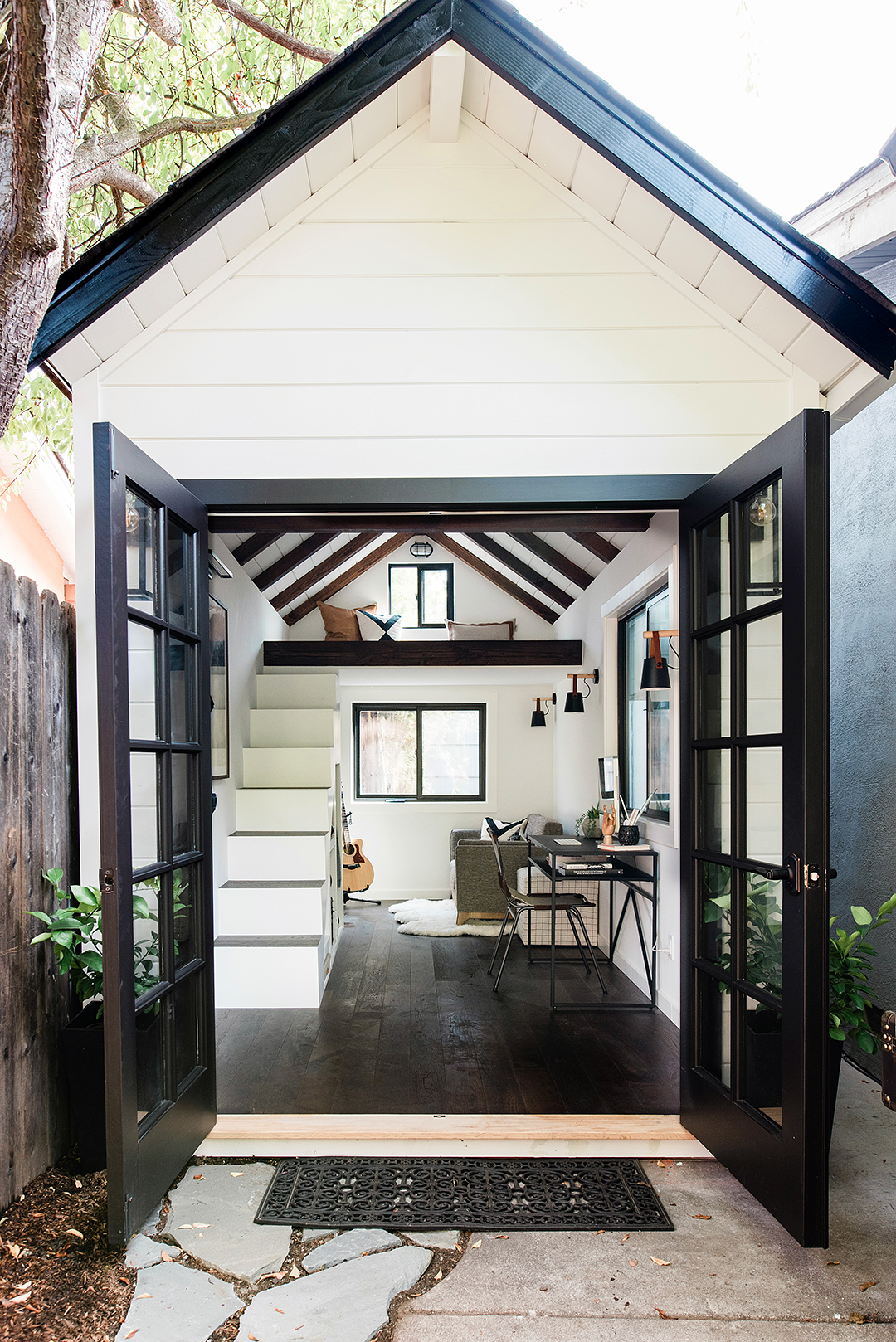 Teen's backyard loft house with doors open.