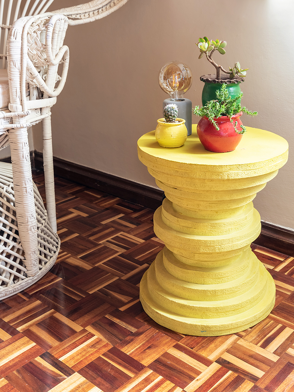 round yellow side table made of stacked discs