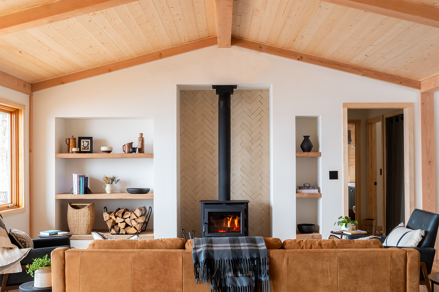 brown leather sofa facing wood-burning stove