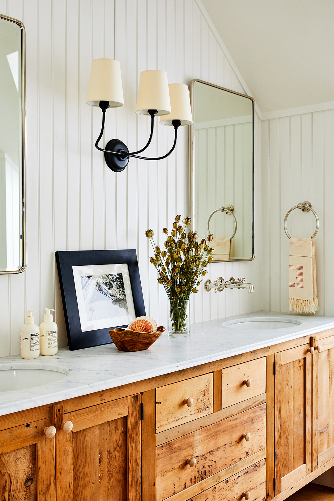 white paneled bathroom with wood vanity