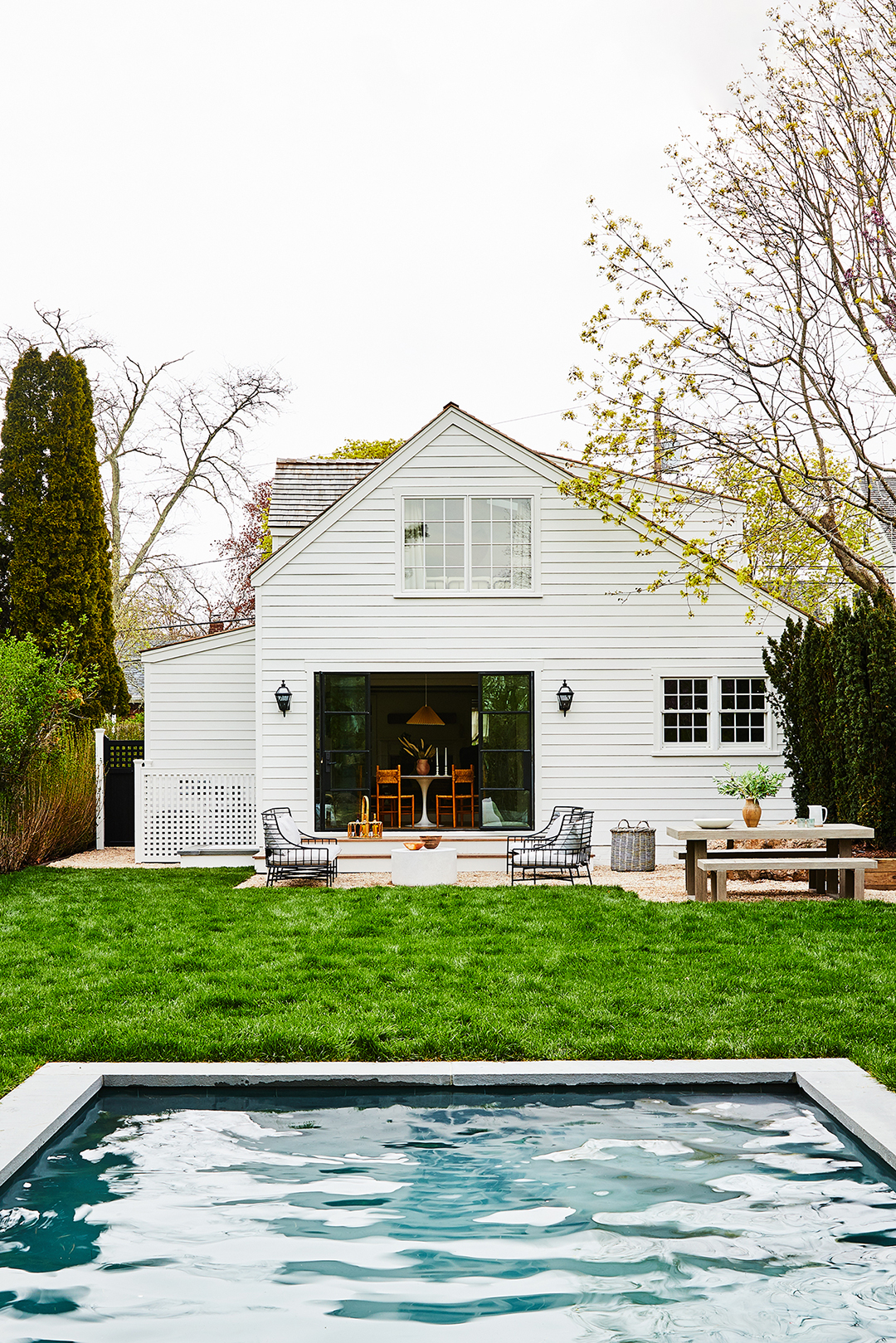 white clapboard house exterior with pool