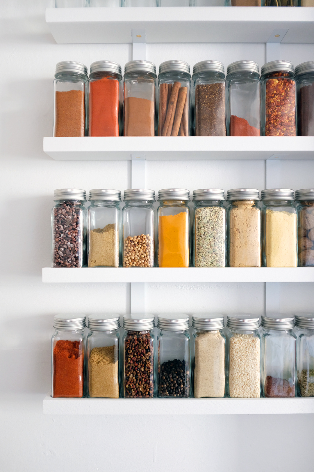 jars of spices on white shelves