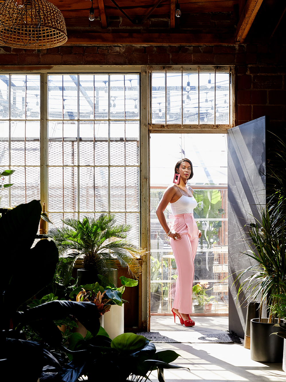 woman in pink jumpsuit in doorway