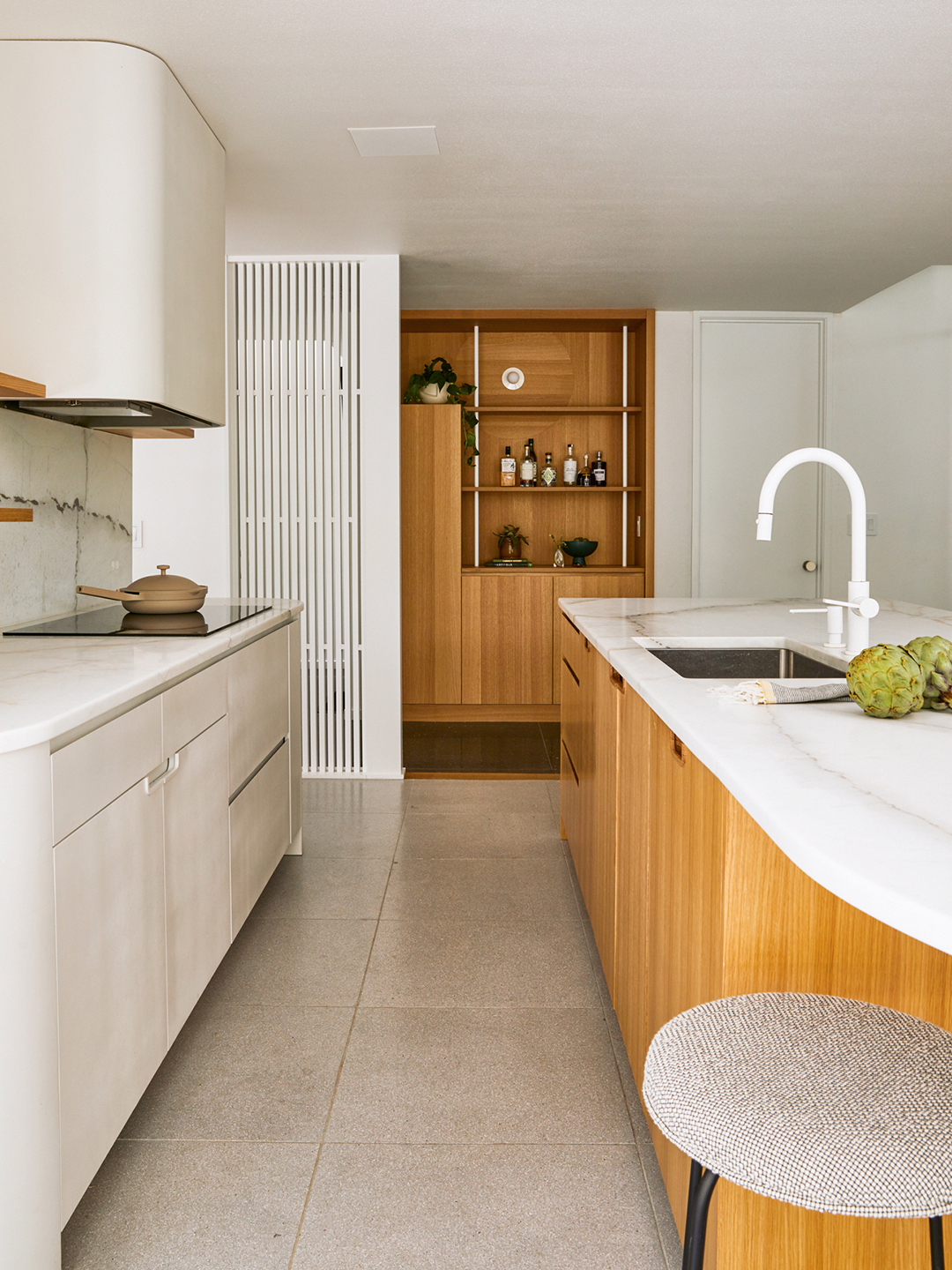 white kitchen with slatted wood island