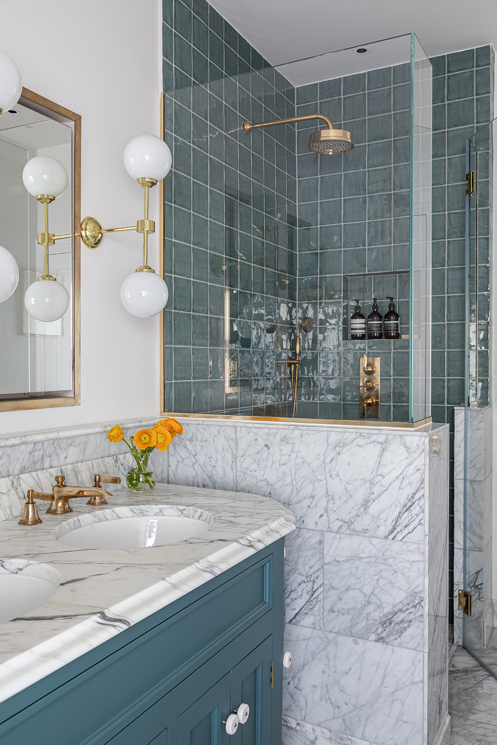 marble bathroom with blue tiled shower