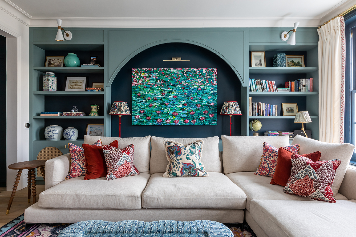 sectional sofa in front of teal arched niche