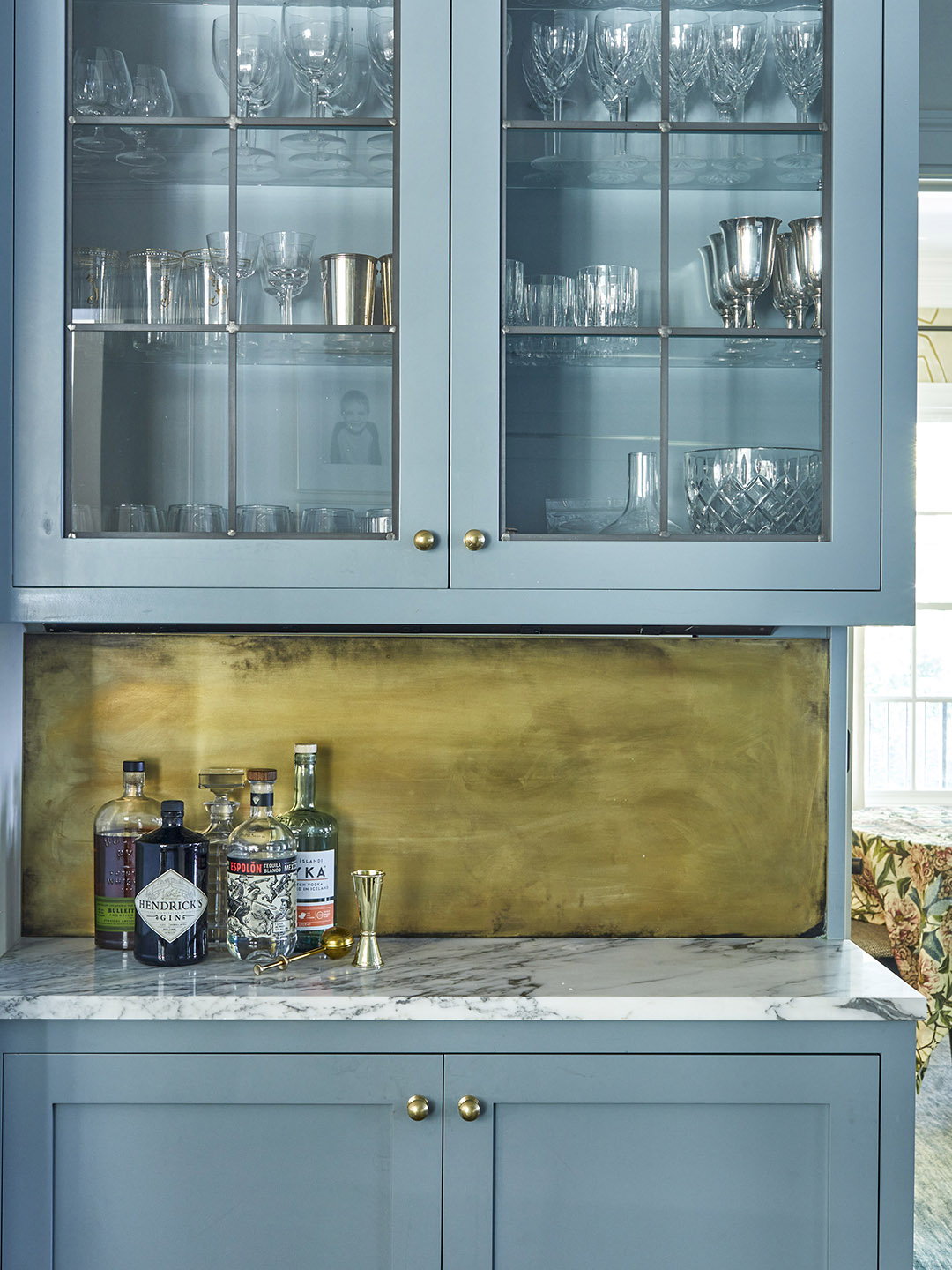 sky blue kitchen with brass backsplash