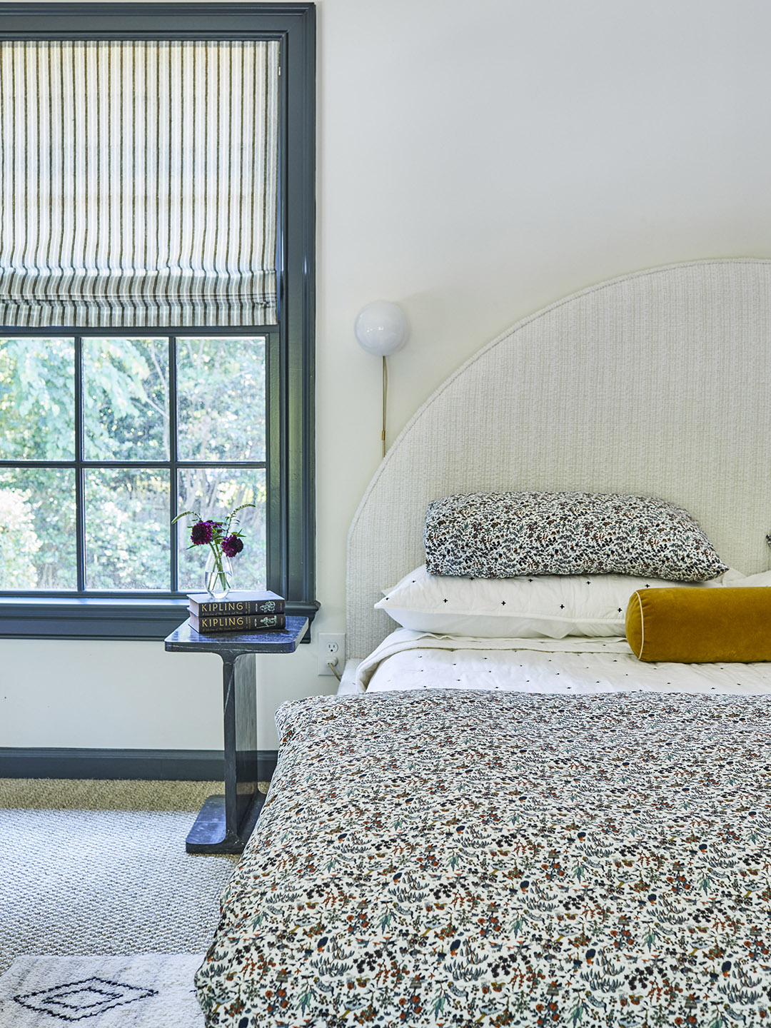 neutral bedroom with curved headboard