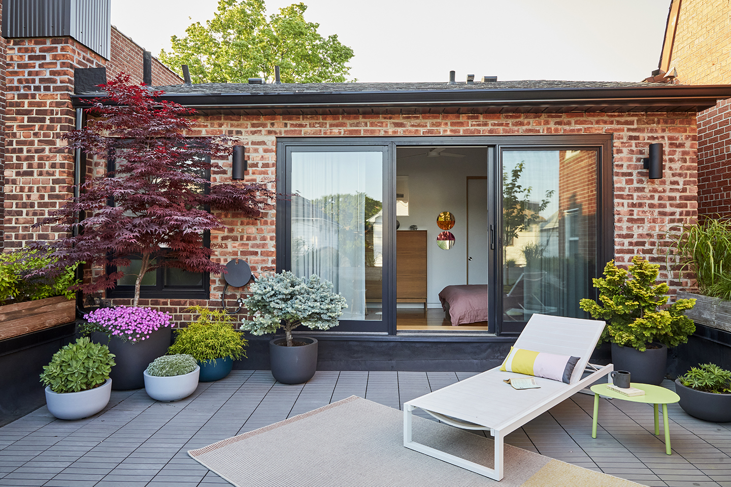 plants and lounge chair on roof deck