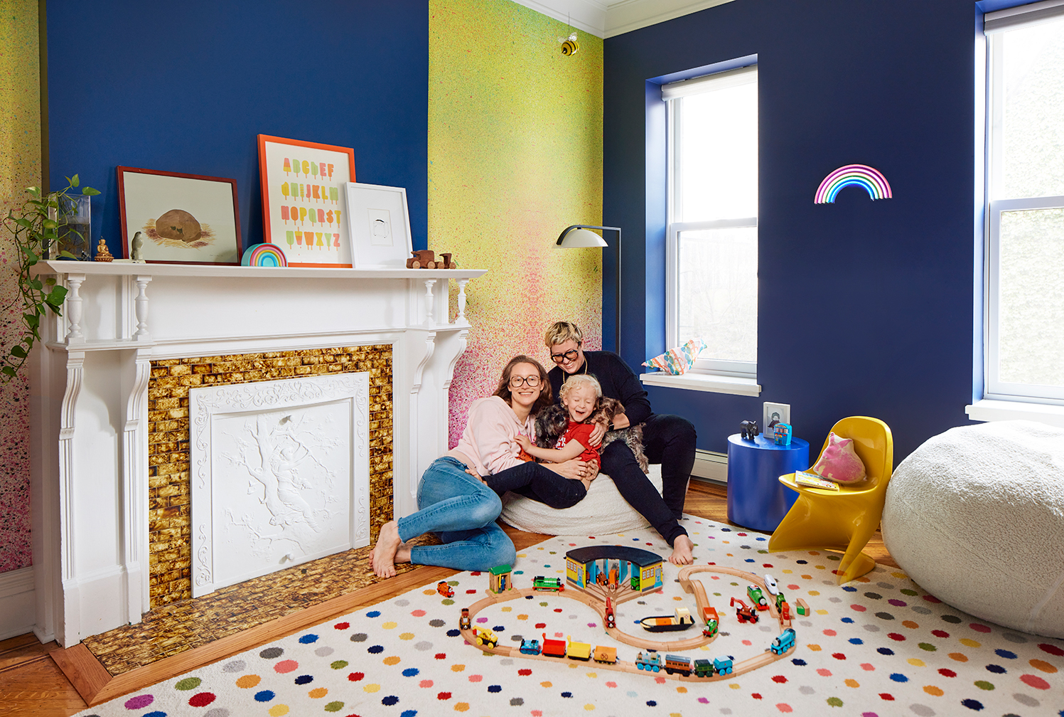 Family of three lounging on bean bag at home in Brooklyn.