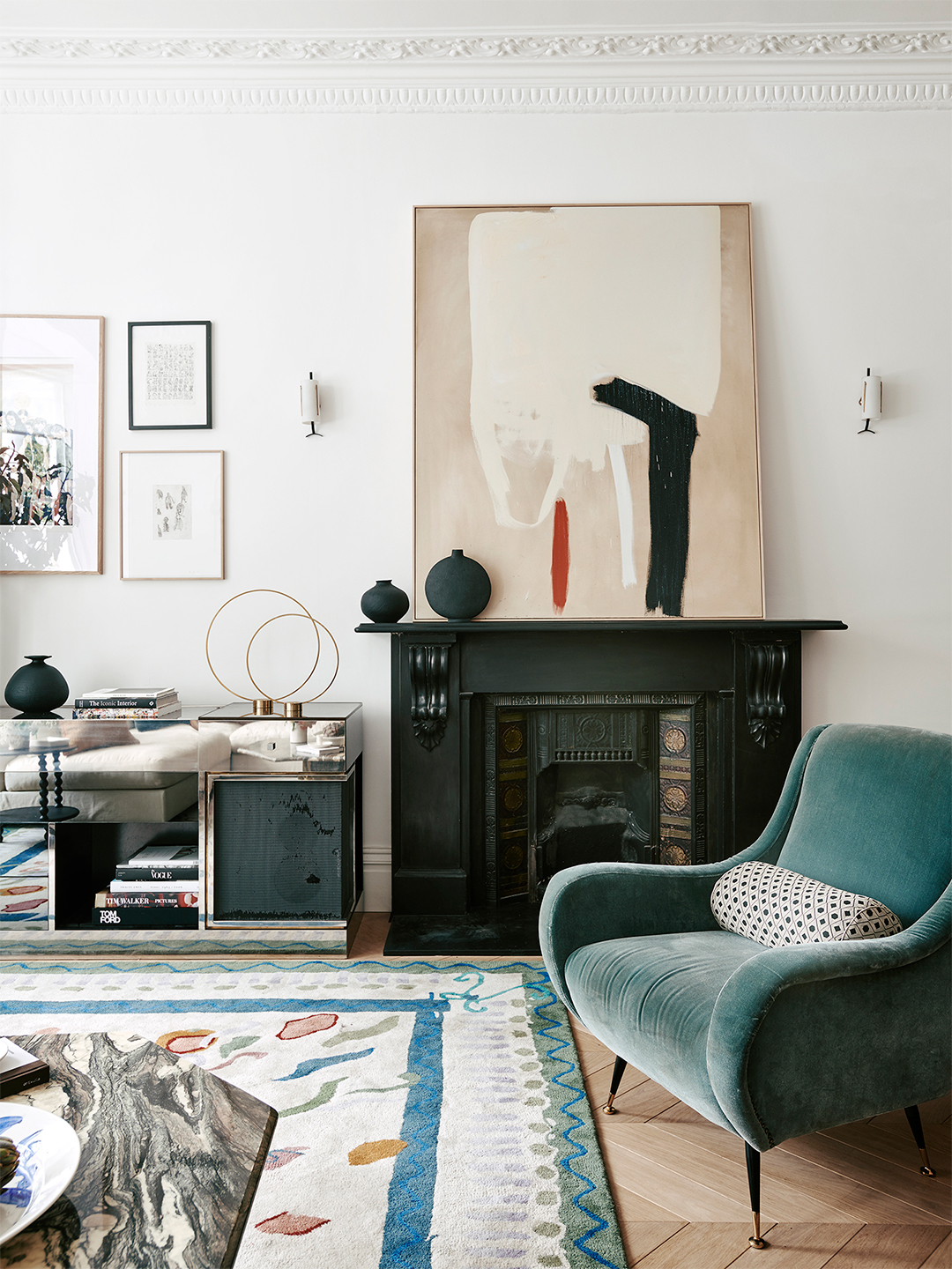 blue velvet chair in front of fireplace