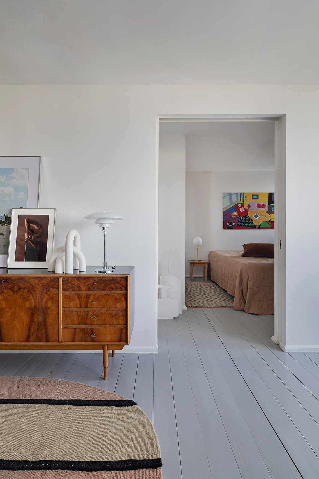 white walls, wooden sideboard