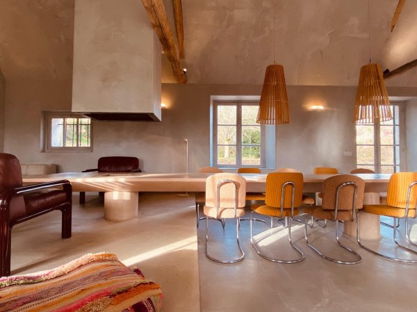 dining area and living room, pink concrete table and fireplace