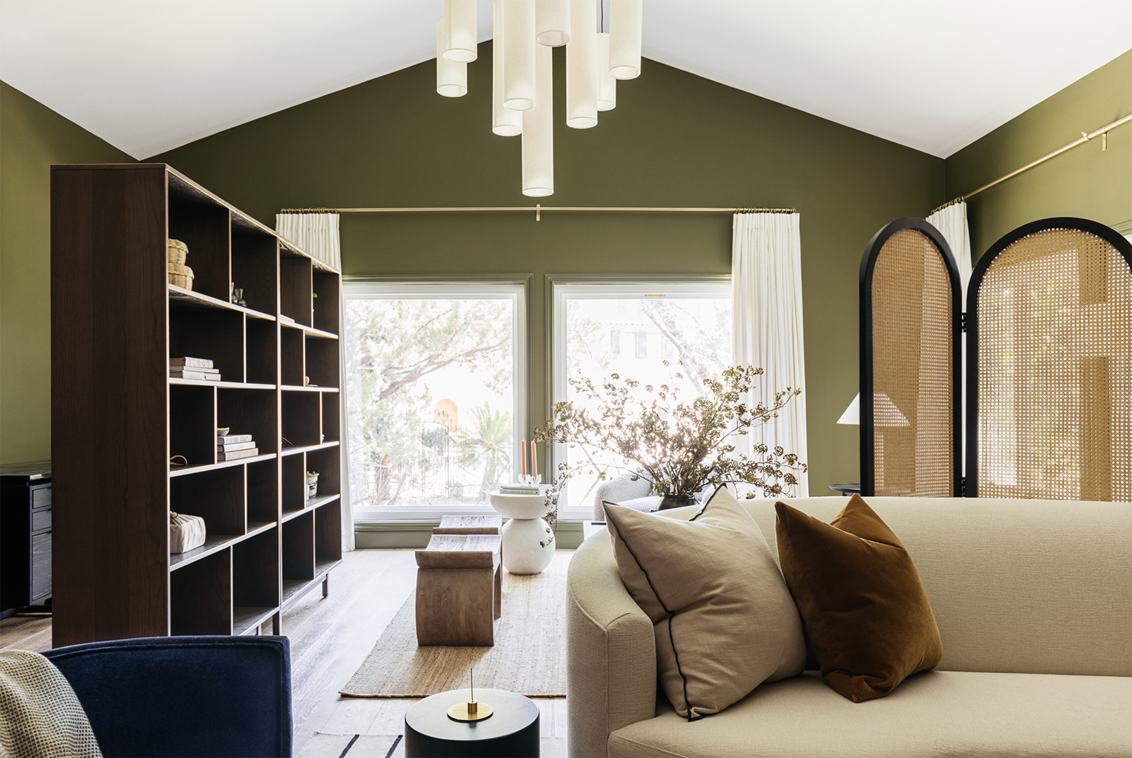 Green living room with large windows