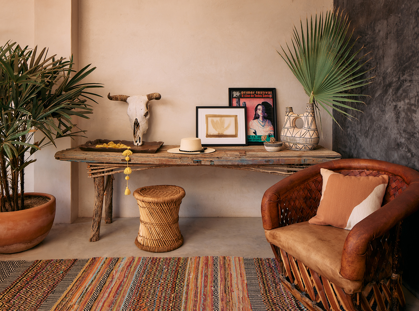 woven armchair next to antique credenza