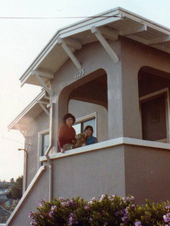 vintage photo, family smiling in front of their house's entry