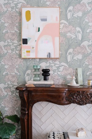 wood mantel with floral wallpaper