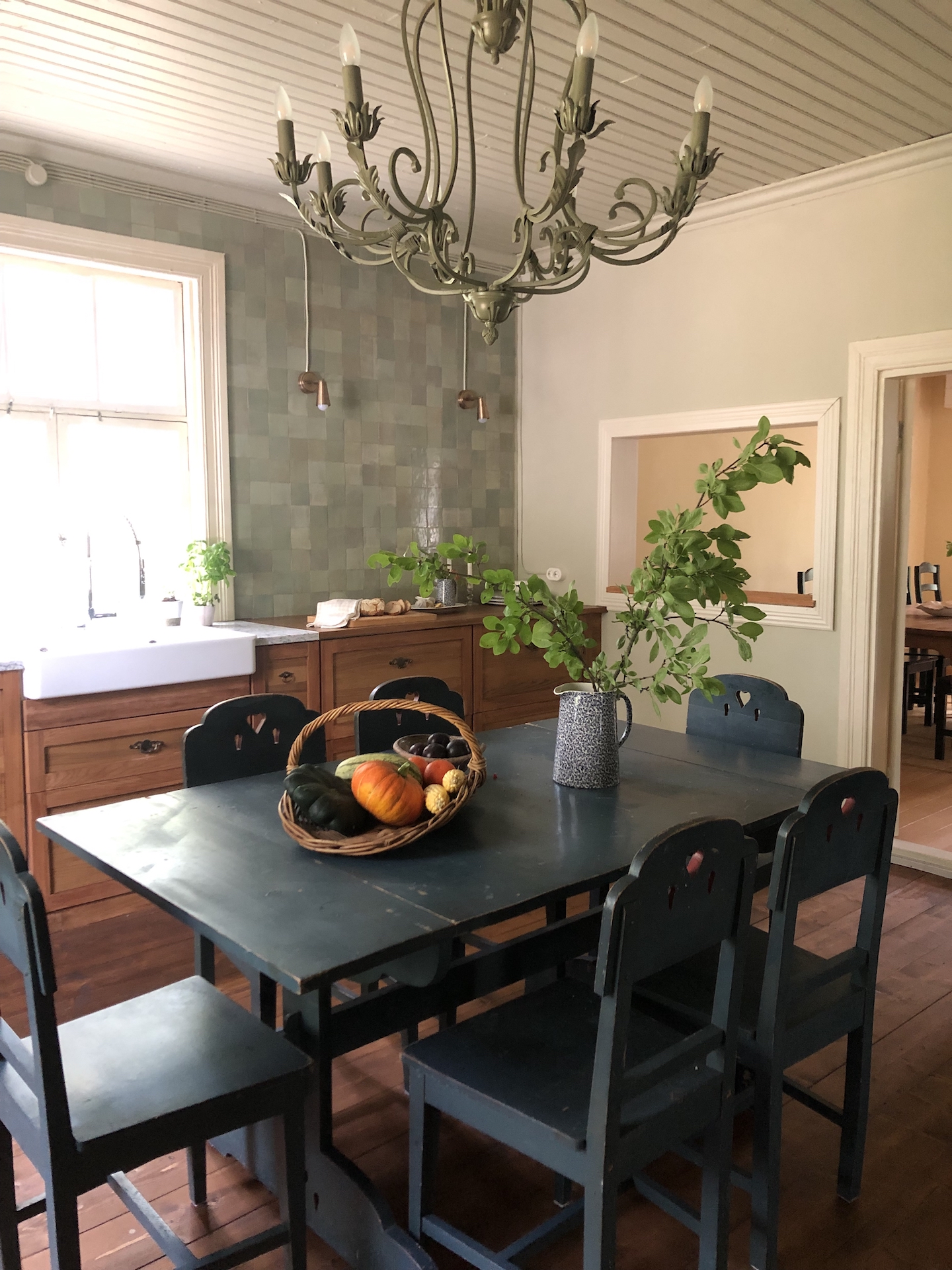 black kitchen table and green chandelier