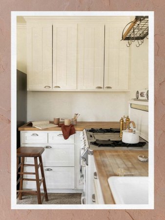 Antique Kitchen With Wood Counters and White Cabinets