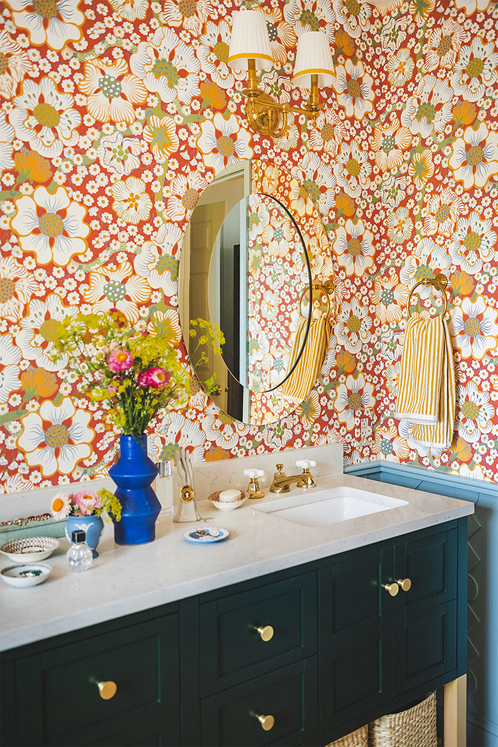 green bathroom vanity with gold mirror