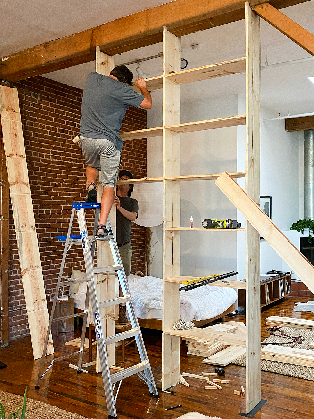 man leveling shelves