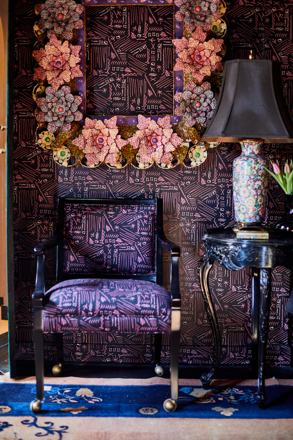 Wallpapered wall and chair with matching upholstery