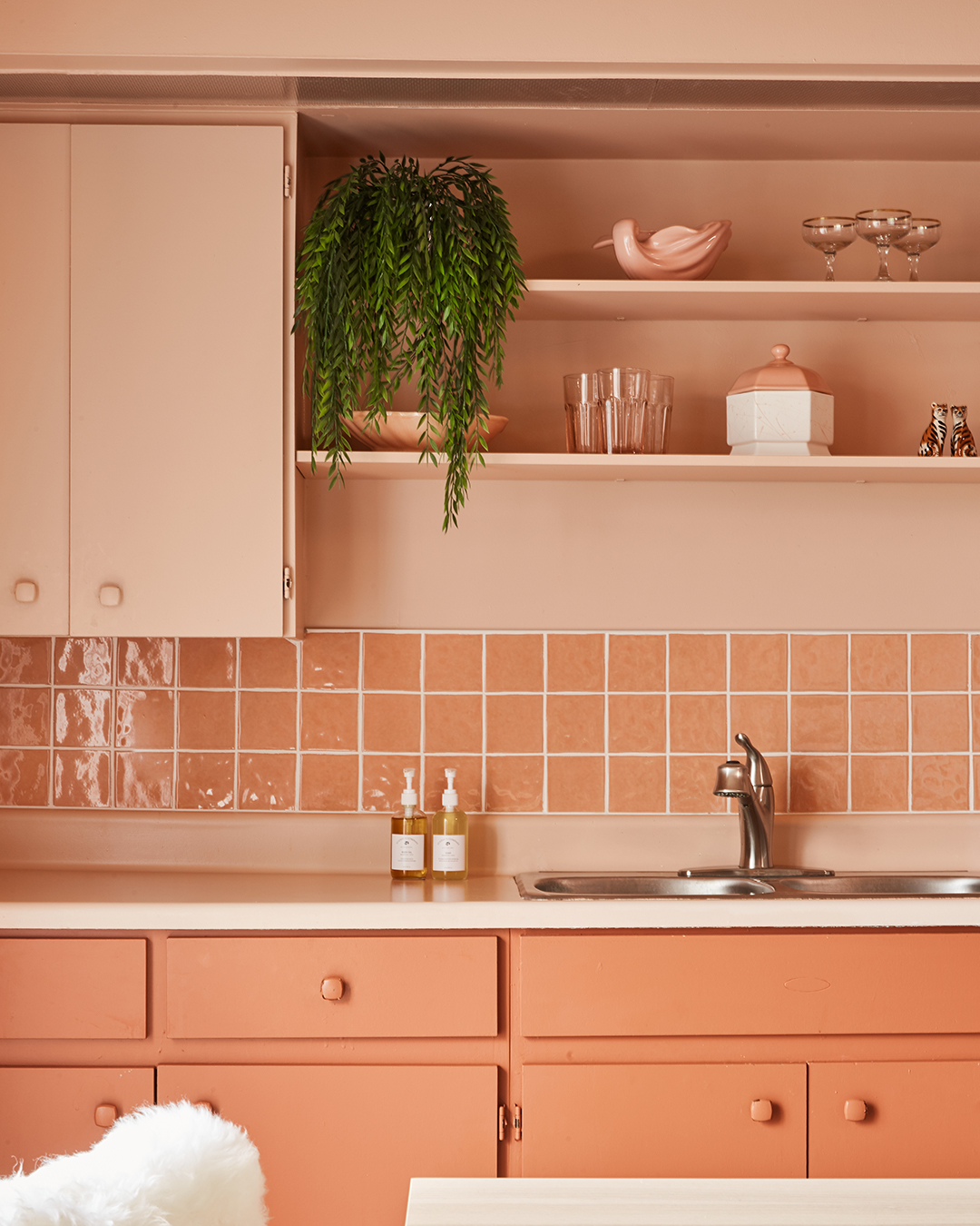 Coral pink kitchen cabinets and tile backsplash