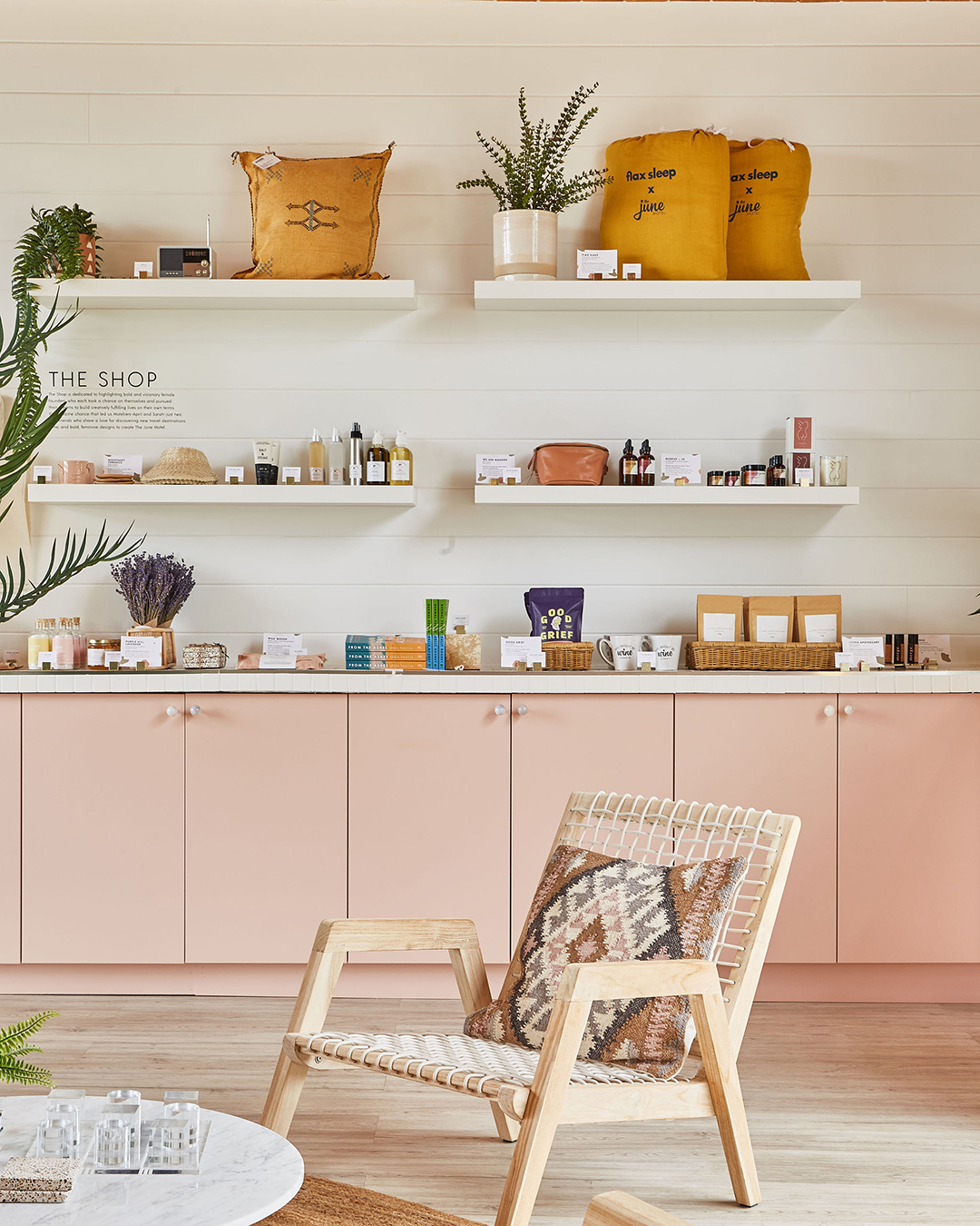 White open shelving and pink cabinets