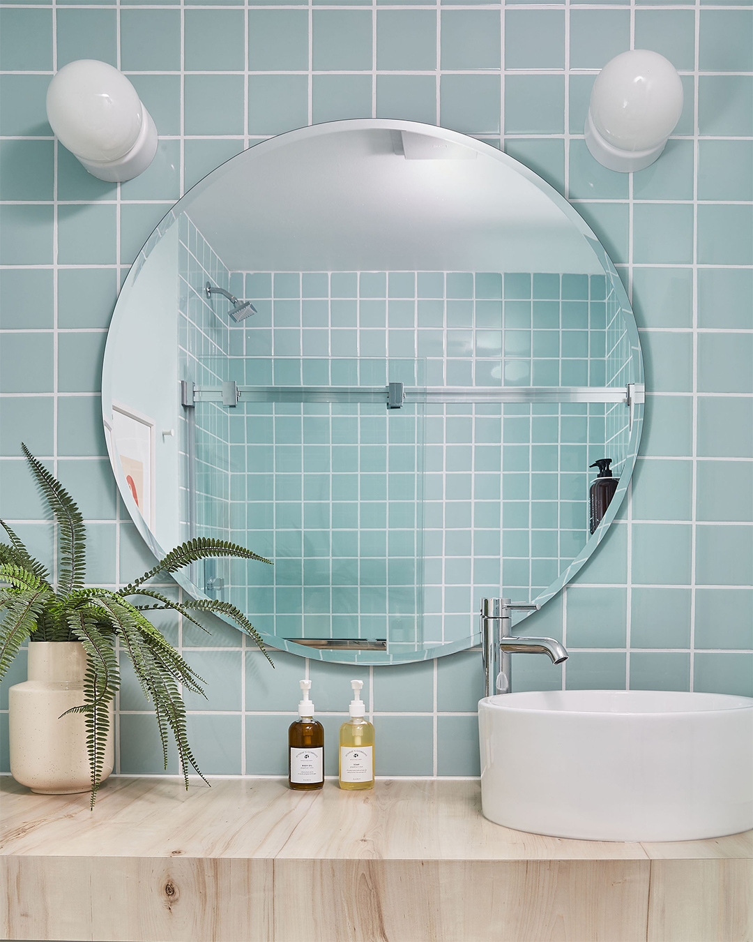 Mirror in blue tile bathroom