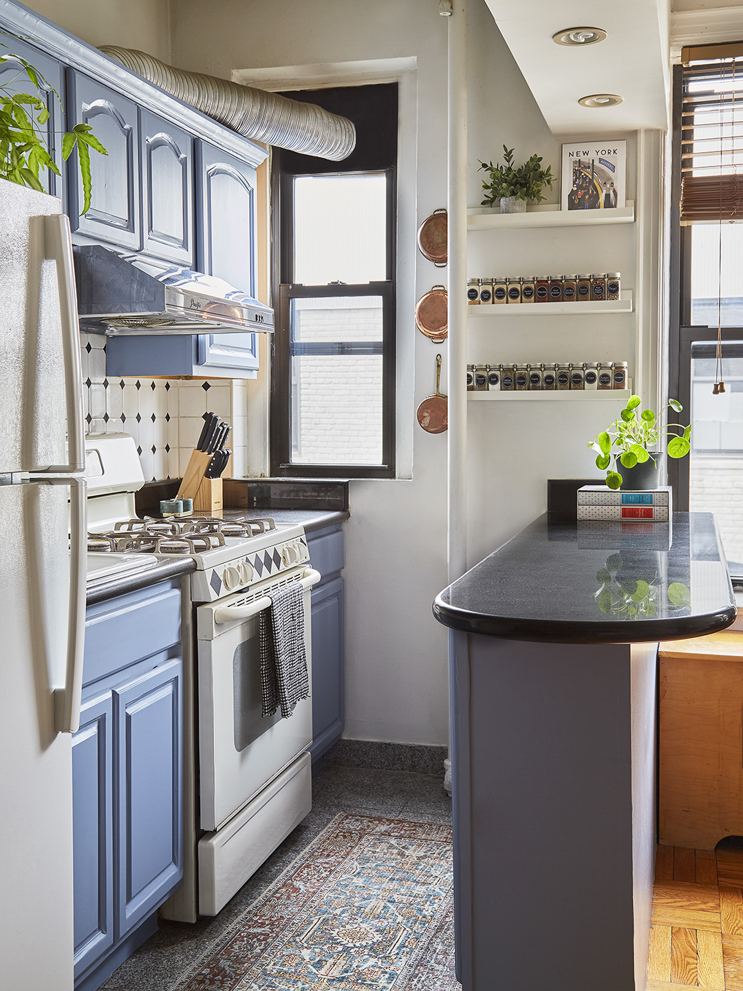 kitchen with blue cabinets and black countertops